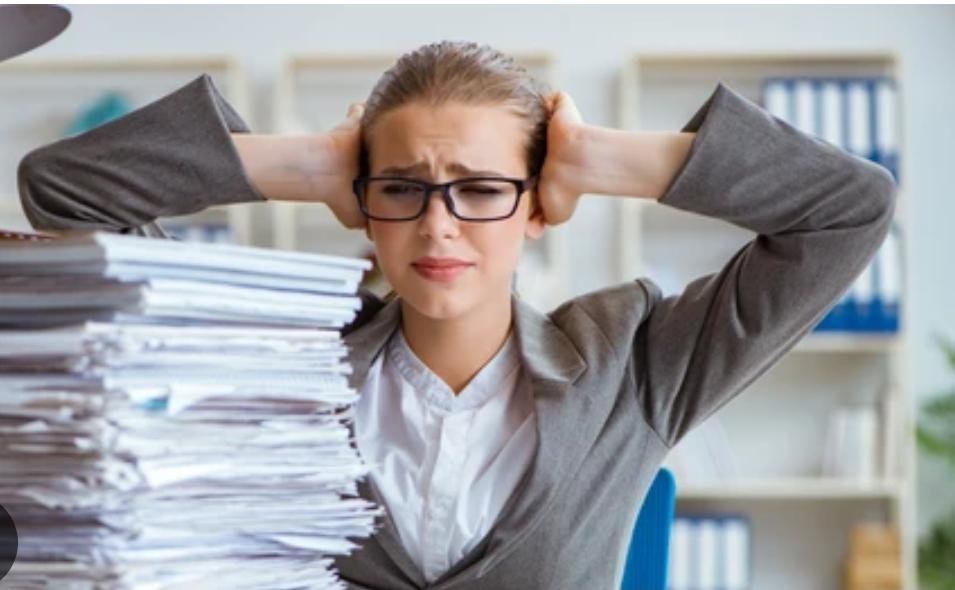 Solo CPA bookkeeping late during busy season, surrounded by paperwork